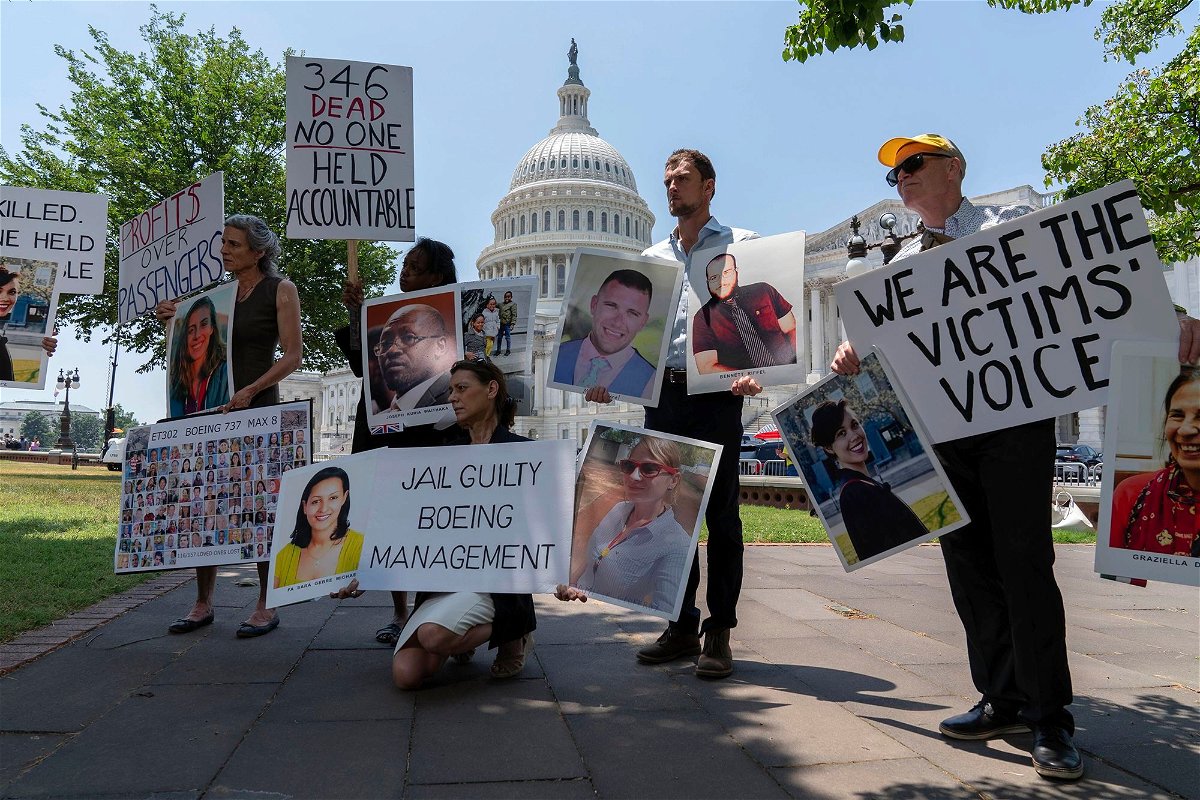 <i>Jose Luis Magana/AP via CNN Newsource</i><br/>Family members of the crash victims of the Boeing 737 MAX crash in Ethiopia hold photographs during a news conference on Capitol Hill.