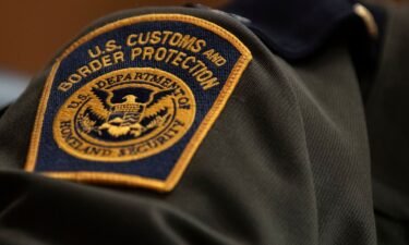 A US Customs and Border Protection patch is seen on an officer's uniform.