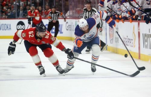 Brandon Montour of the Florida Panthers and Leon Draisaitl of the Edmonton Oilers play the puck in Game 5 of the 2024 Stanley Cup Final at the Amerant Bank Arena on June 18.