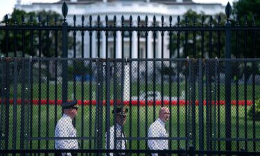Law enforcement officials walk around the security fencing set around the White House complex on June 7 in Washington