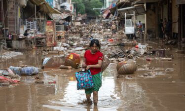 Villager walks on muddy streets as torrential rains cause flooding on June 19 in Meizhou