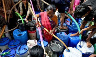 Residents fill their containers with water supplied by a municipal tanker in New Delhi on June 19.