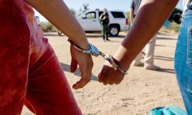 Migrants who illegally crossed into the US from Mexico are arrested by US Border Patrol agents on June 14
