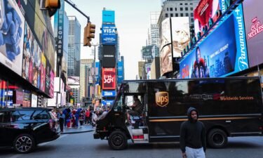 A UPS truck driver maneuvers his delivery truck through Times Square in New York on May 1