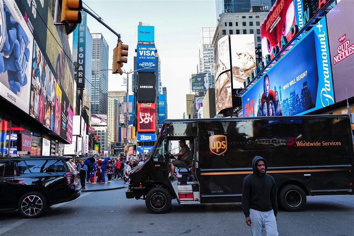 <i>Charly Triballeau/AFP/Getty Images via CNN Newsource</i><br/>A UPS truck driver maneuvers his delivery truck through Times Square in New York on May 1
