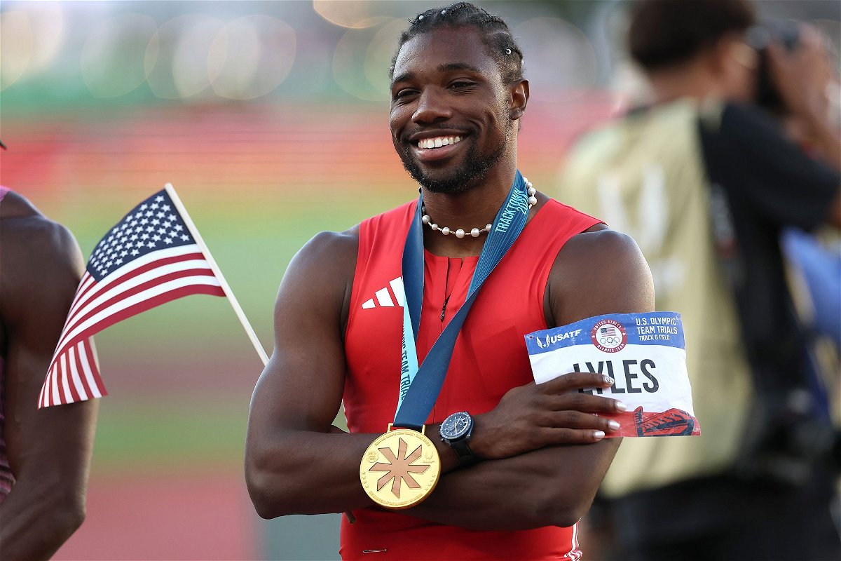 <i>Patrick Smith/Getty Images via CNN Newsource</i><br/>Lyles poses with the flag and his gold medal after the race.