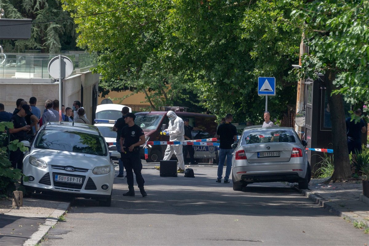 <i>Marko Drobnjakovic/AP via CNN Newsource</i><br/>Police officers work at the crime scene close to the Israeli embassy in Belgrade on June 28.