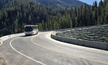 A bus drives on Wyoming Highway 22/Teton Pass