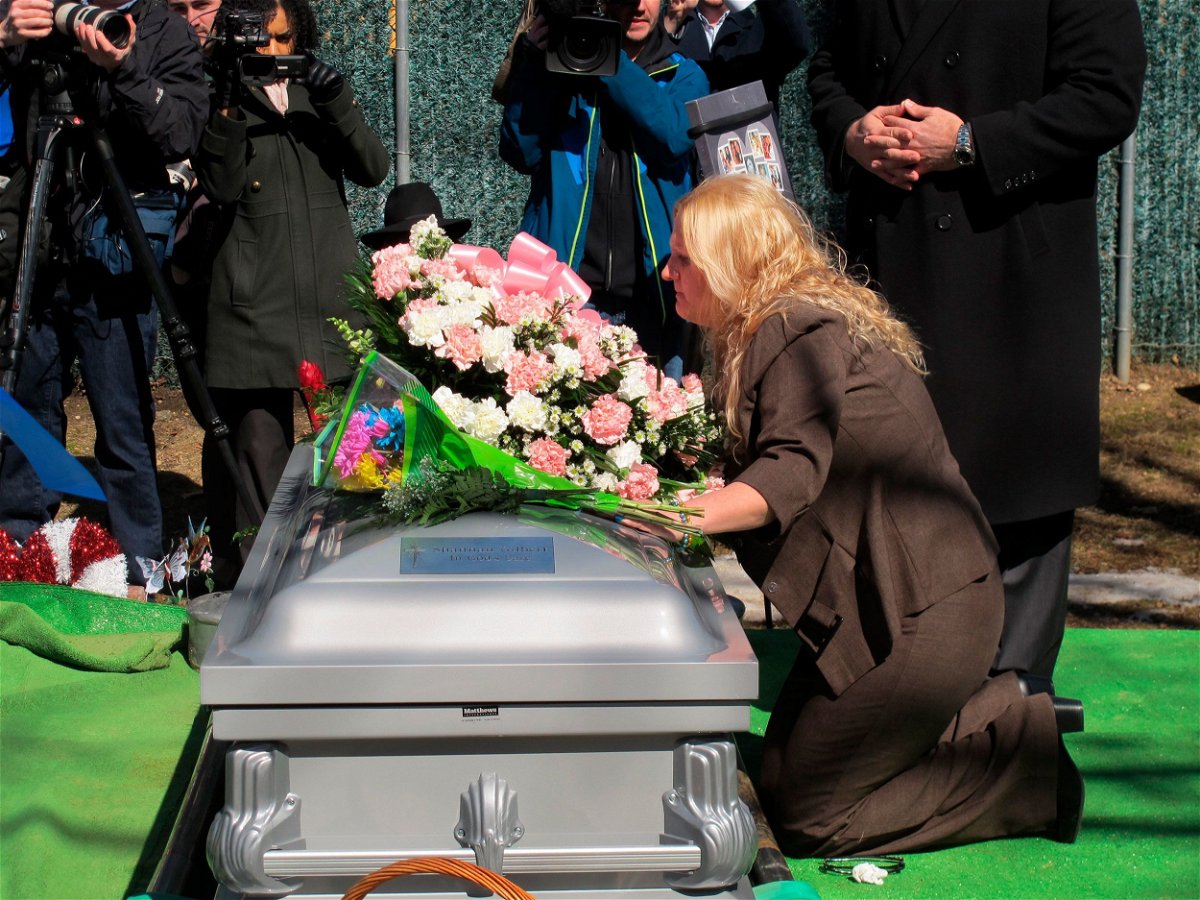 <i>Frank Eltman/AP via CNN Newsource</i><br/>Mari Gilbert kneels over the coffin of her daughter Shannan Gilbert at Amityville Cemetery in March 2015.