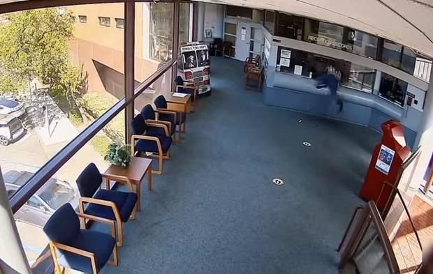 <i>Pinole Police Department/KPIX via CNN Newsource</i><br/>A man is seen climbing through the window of the reception area at the Pinole Public Safety Building