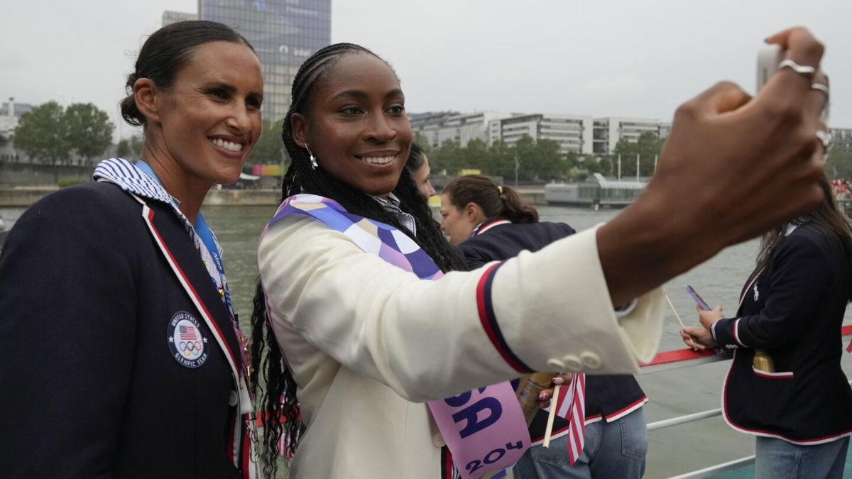 United States' Coco Gauff poses with members of the U.S. team in Paris during the Opening Ceremony