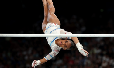 Melanie de Jesus dos Santos of France competes on the uneven bars during the women's qualification round at the 2024 Paris Olympics.