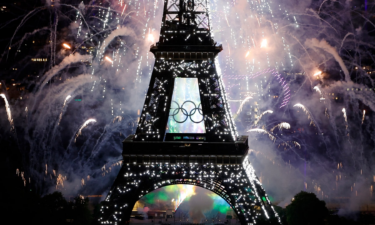 Olympic Rings are seen on the Eiffel Tower during fireworks to celebrate the annual Bastille Day in Paris