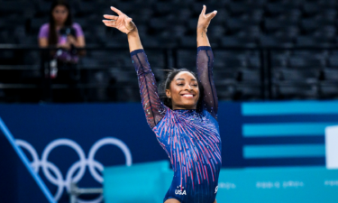 Simone Biles salutes with a smile during podium training session ahead of the Paris 2024 Olympics Games.