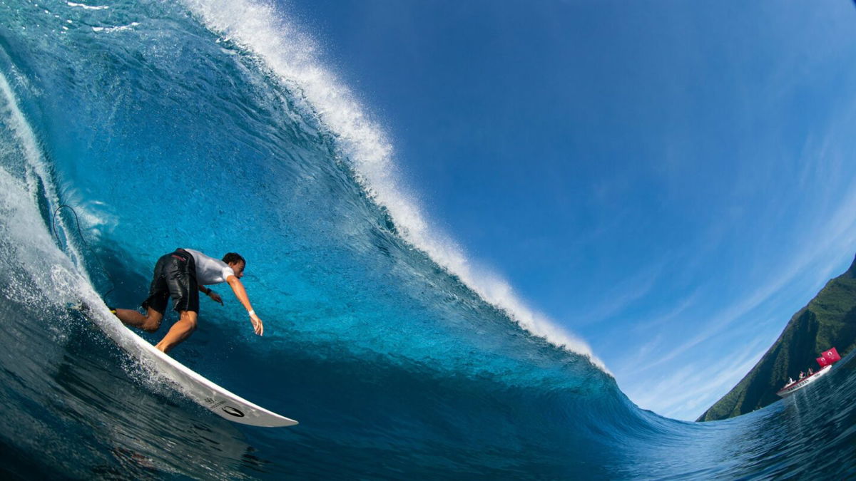 A surfer rides a wave in Teahupo'o