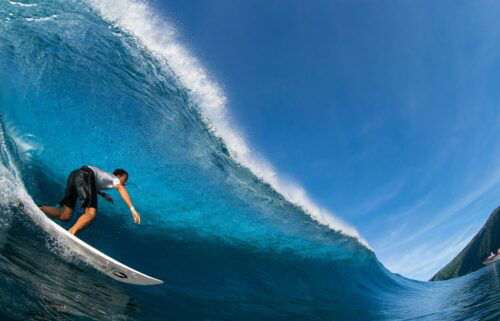 A surfer rides a wave in Teahupo'o