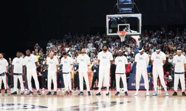 Members of the 2024 U.S. men's basketball Olympic team stand in a line before a game
