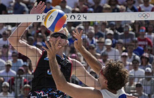 Chase Budinger (USA) and Arnaud Gauthier-Rat (FRA) in action in a beach volleyball preliminary phase match during the 2024 Paris Olympics.