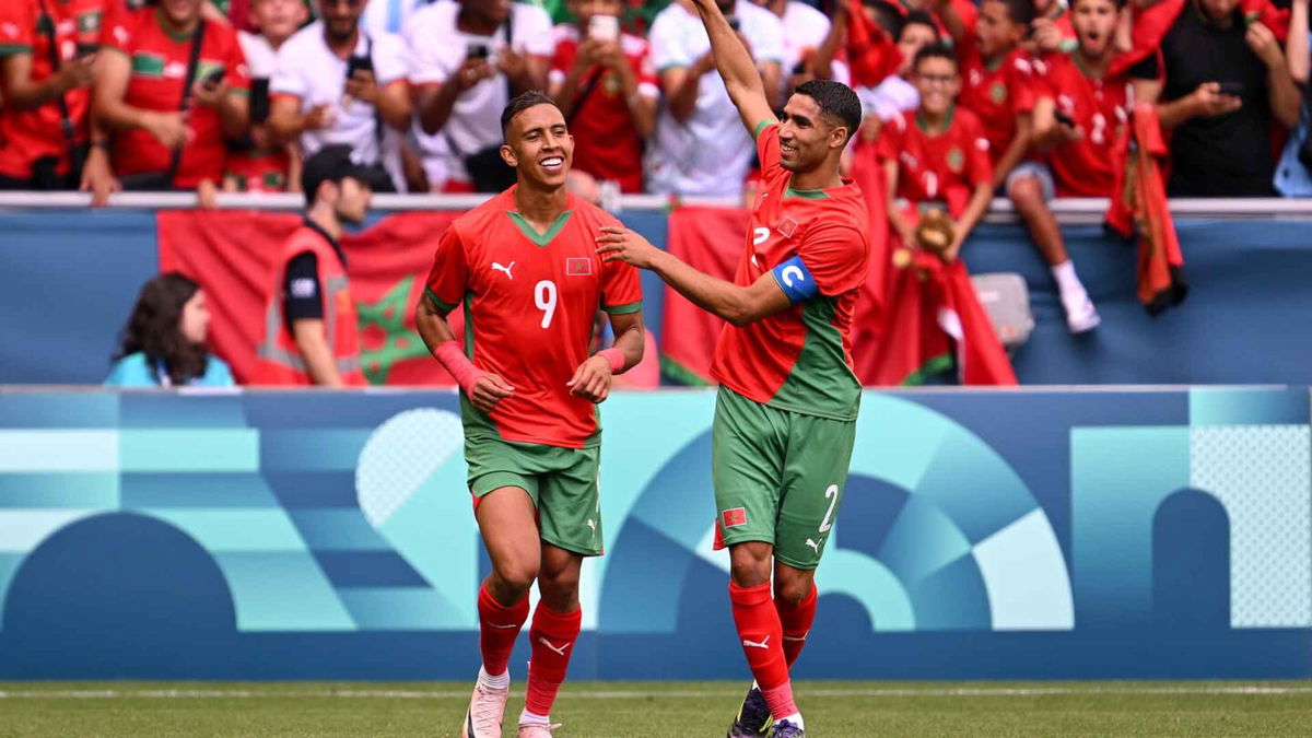 Morocco players celebrate after scoring goal.