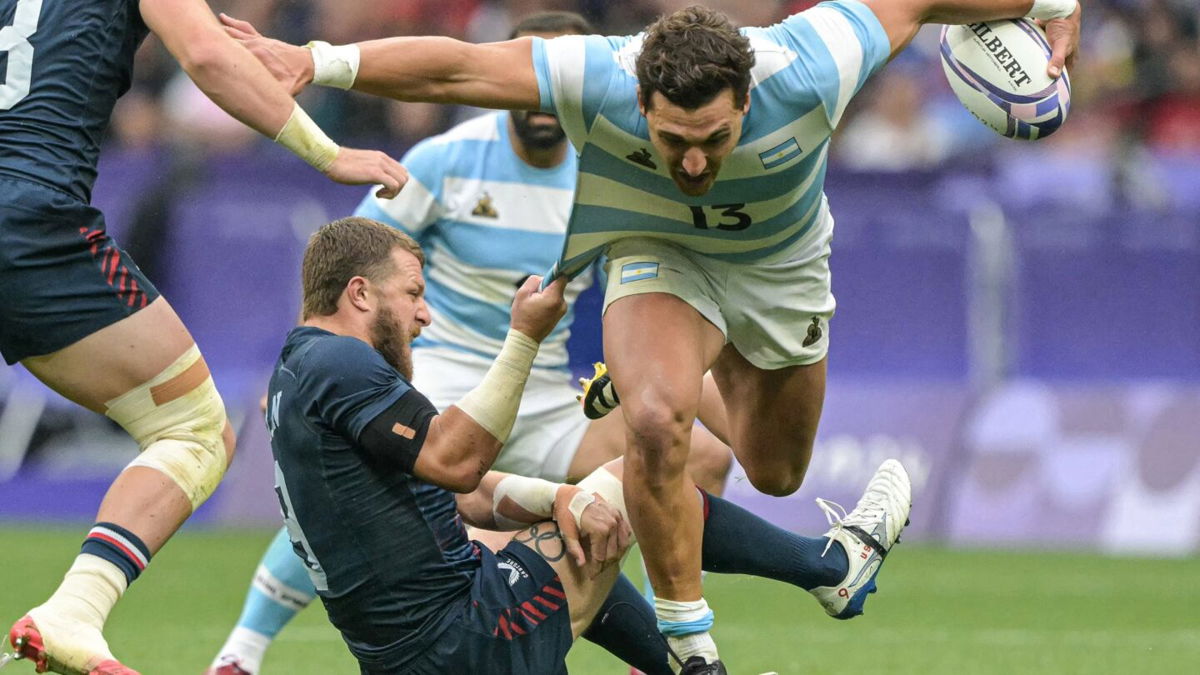 Argentina's Rodrigo Isgro is tackled by the U.S.'s Stephen Tomasin during the men's placing 7-8 rugby sevens match during the 2024 Olympic Games.
