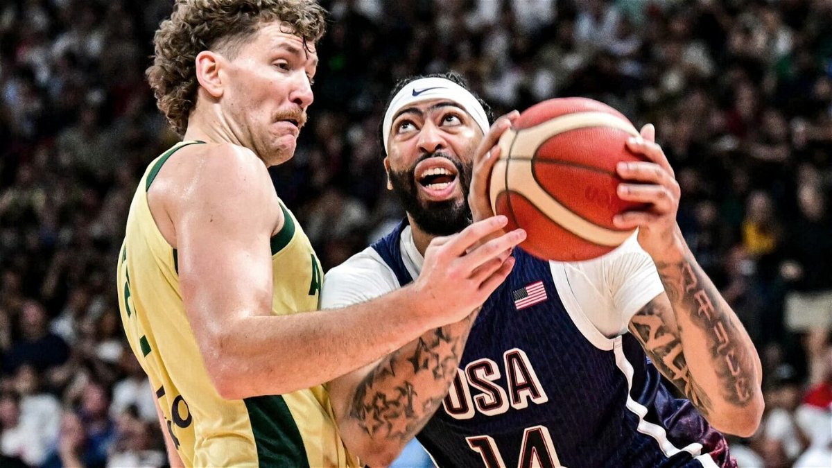 Australia's centre #22 Will Magnay vies for the ball against USA's forward #14 Anthony Davis during the Basketball Showcase friendly match between the United States and Australia at Etihad Arena in Abu Dhabi on July 15