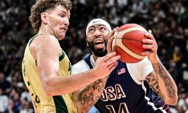 Australia's centre #22 Will Magnay vies for the ball against USA's forward #14 Anthony Davis during the Basketball Showcase friendly match between the United States and Australia at Etihad Arena in Abu Dhabi on July 15