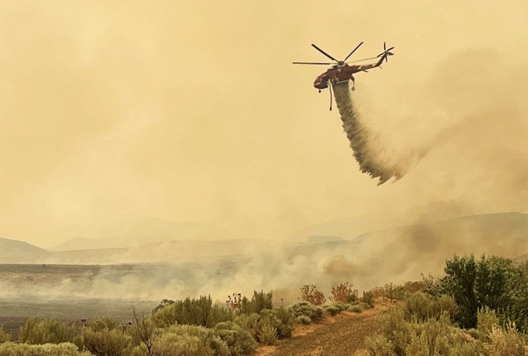 Water-dropping helicopters are part of the fight to stop the Cow Valley Fire in Malheur County.