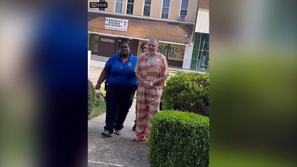 <i>KTBS via CNN Newsource</i><br/>Greg Lawson is escorted to the Claiborne Parish Courthouse Monday.