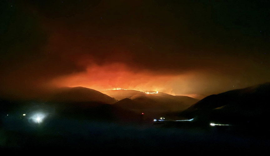 The Larch Creek Fire in Wasco County glows as crews continued battling it into the night