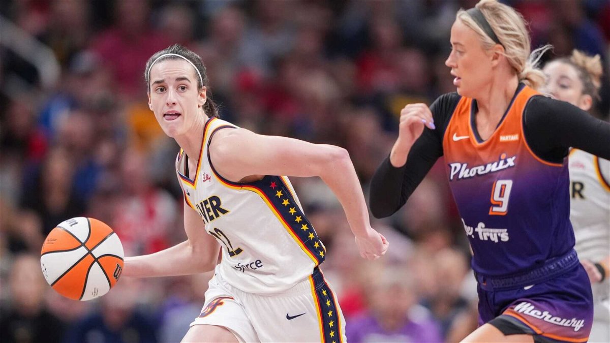 Indiana Fever guard Caitlin Clark (22) rushes up the court against Phoenix Mercury guard Sophie Cunningham (9) on Friday