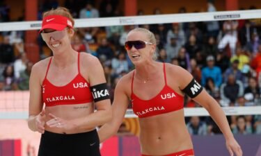 kelly cheng and sara hughes smile on beach volleyball court
