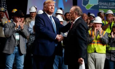 President Donald Trump shakes hands with Continental Resources CEO Harold Hamm at an event in Pittsburgh in 2019.