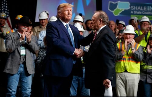 President Donald Trump shakes hands with Continental Resources CEO Harold Hamm at an event in Pittsburgh in 2019.
