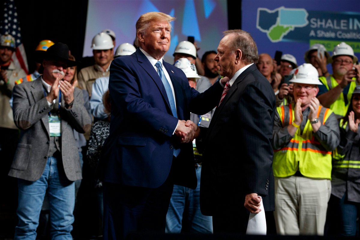 <i>Evan Vucci/AP via CNN Newsource</i><br/>President Donald Trump shakes hands with Continental Resources CEO Harold Hamm at an event in Pittsburgh in 2019.