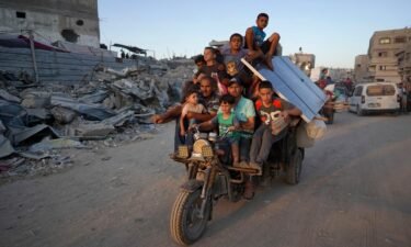 Displaced Palestinians leave an area in east Khan Younis after the Israeli army issued a new evacuation order for parts of the city and Rafah