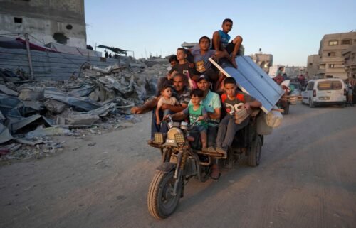 Displaced Palestinians leave an area in east Khan Younis after the Israeli army issued a new evacuation order for parts of the city and Rafah