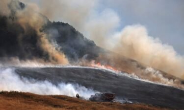 A wildfire spreads uphill west of Petaluma