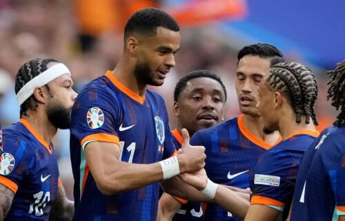 Cody Gakpo celebrates with his teammates after scoring the Netherlands' first goal against Romania.