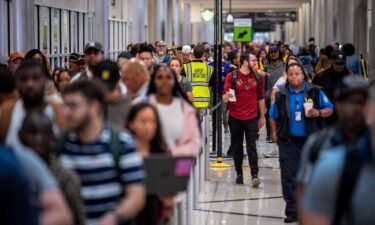 Travelers stand in a long line for security screening at Hartsfield-Jackson Atlanta International Airport on June 28. The Transportation Security Administration (TSA) says it is anticipating a "sustained period of high passenger volumes" that will break previous travel records.