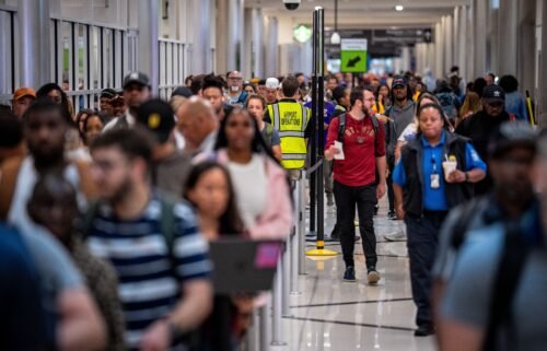 Travelers stand in a long line for security screening at Hartsfield-Jackson Atlanta International Airport on June 28. The Transportation Security Administration (TSA) says it is anticipating a "sustained period of high passenger volumes" that will break previous travel records.
