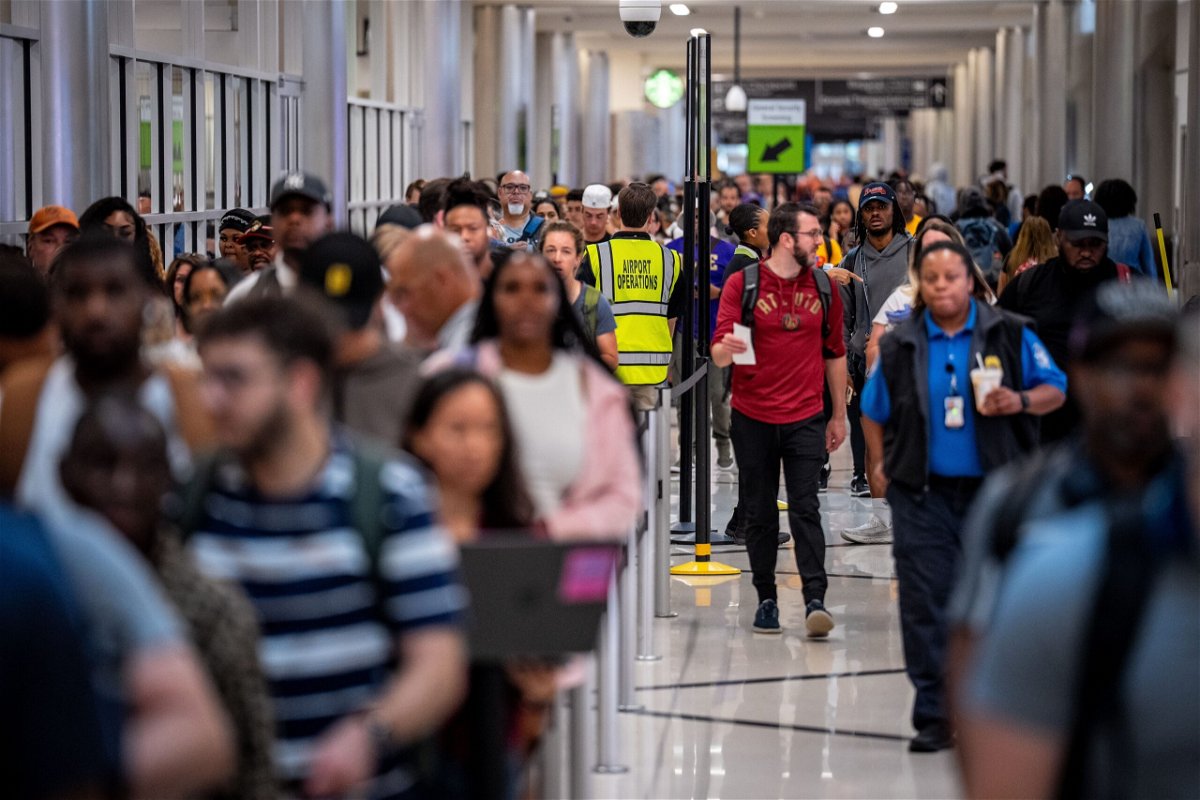 <i>Andrew Harnik/Getty Images via CNN Newsource</i><br/>Travelers stand in a long line for security screening at Hartsfield-Jackson Atlanta International Airport on June 28. The Transportation Security Administration (TSA) says it is anticipating a 