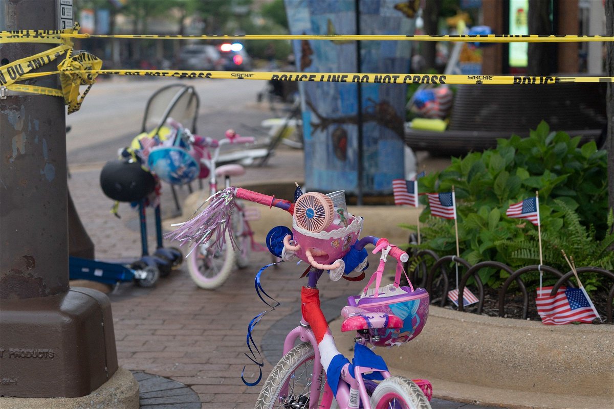 <i>Youngrae Kim/AFP/Getty Images/File via CNN Newsource</i><br/>Police crime tape is seen around the area where children's bicycles and baby strollers stand near the scene of the Fourth of July parade shooting that killed seven people in Highland Park