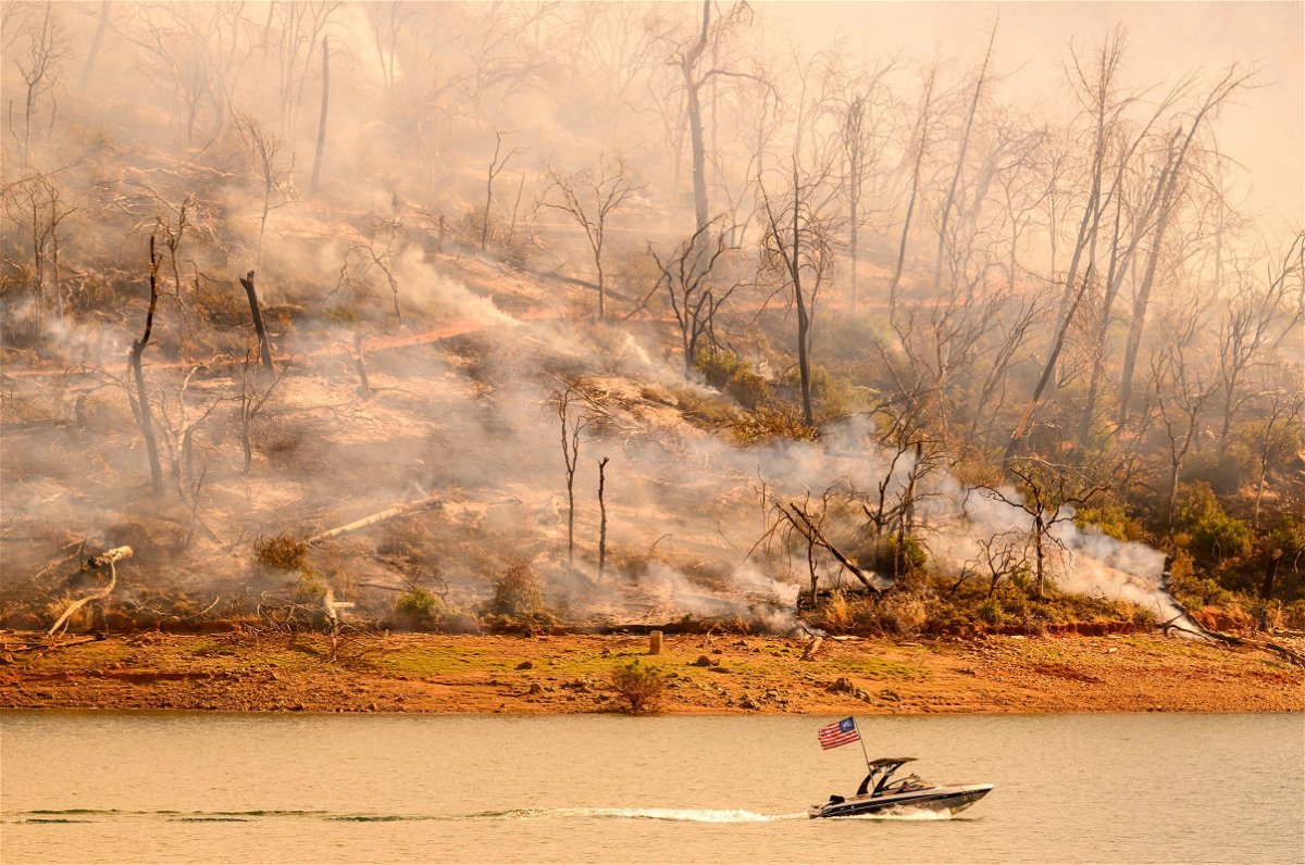 <i>Josh Edelson/AFP/Getty Images via CNN Newsource</i><br/>A boat moves along Lake Oroville as the Thompson Fire continues to burn in Oroville