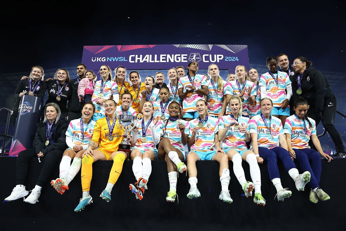 <i>Tim Nwachukwu/Getty Images via CNN Newsource</i><br/>San Diego Wave players and coaches pose for a team photo after winning the 2024 NWSL Challenge Cup.