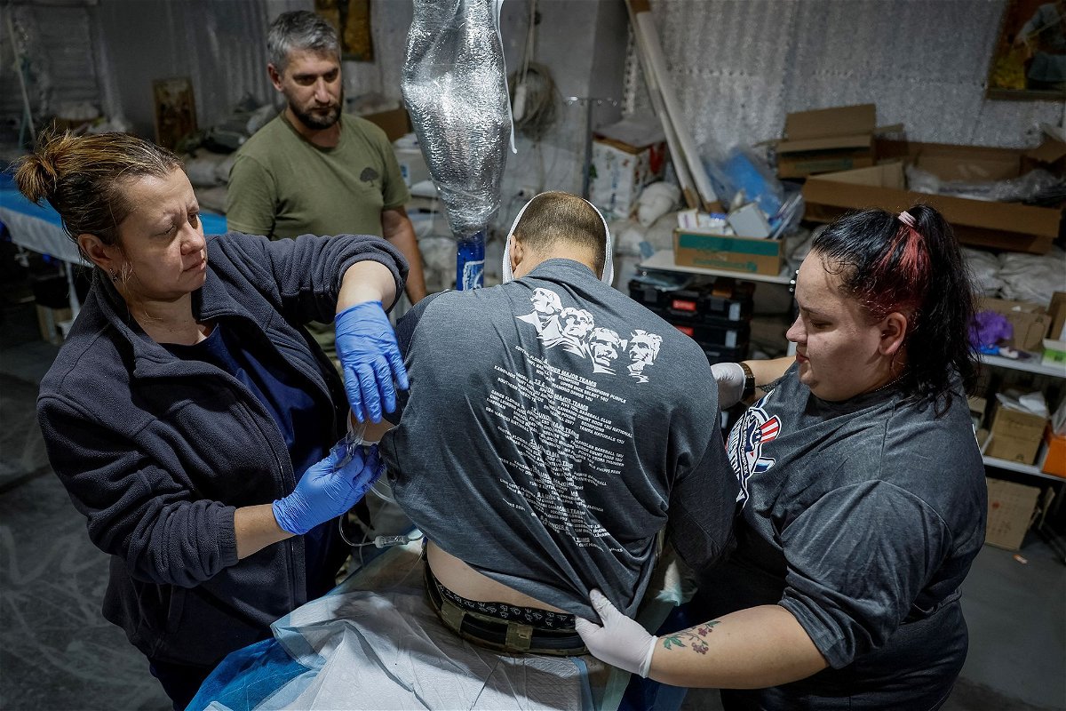 <i>Alina Smutko/Reuters via CNN Newsource</i><br/>Medics prepare for transportation of a wounded Ukrainian serviceman inside a medical stabilization point near Chasiv Yar on July 1.