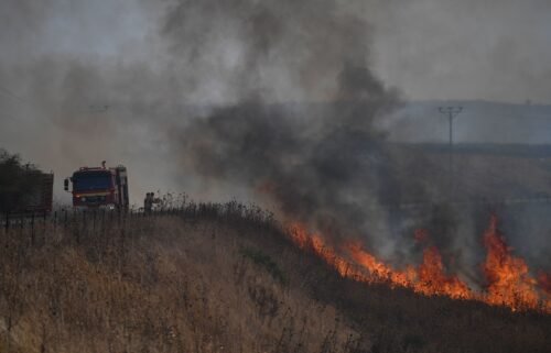 Firefighters work to extinguish a blaze following an attack from Hezbollah in the Israeli-controlled Golan Heights.