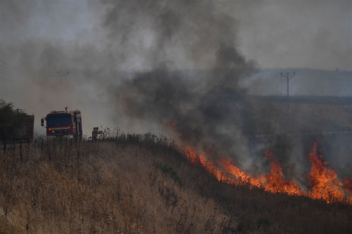 <i>Gil Eliyahu/AP via CNN Newsource</i><br/>Firefighters work to extinguish a blaze following an attack from Hezbollah in the Israeli-controlled Golan Heights.