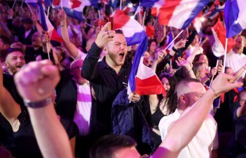 Supporters react as former president of the French far-right Rassemblement National (RN) parliamentary group Marine Le Pen gives a speech during the results evening of the first round of the parliamentary elections in Henin-Beaumont