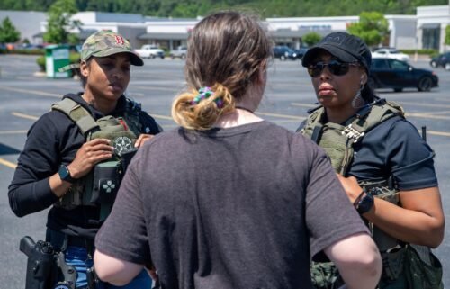 Two US marshals speak with an individual during Operation We Will Find You 2.