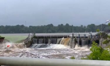 Water rushes from Manawa Dam in Wisconsin on Friday.